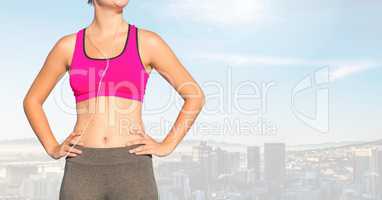 Fitness woman Torso listening music against sky background