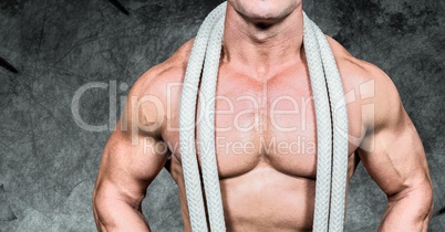 Composite image of man Fitness Torso against dark background