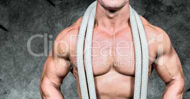 Composite image of man Fitness Torso against dark background