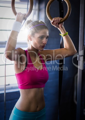 Woman doing pull ups with flare in a gym