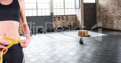 Fitness woman Torso measuring her size in a gym