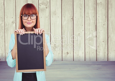 Composite image of Woman with blackboard in wood room