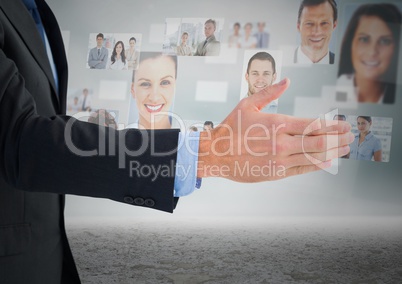 Composite image of Handshake in front of sky with business people