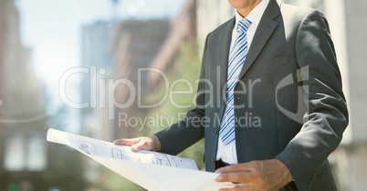 Architect Torso holding plans in the street