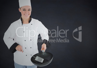 Chef with pan against black background