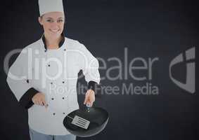 Chef with pan against black background