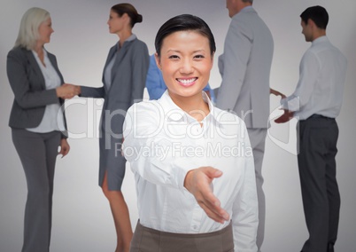 Composite image of Handshake in front of business people with white background