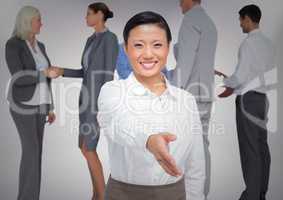 Composite image of Handshake in front of business people with white background