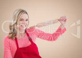 Woman with rolling pin against cream background