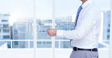 Businessman Torso holding a pen against windows