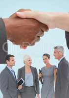 Handshake with business people and blue background