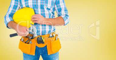 Carpenter with hammer against yellow background