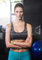 Fitness woman arms folded in a gym