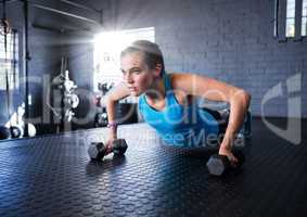 Fitness woman making fitness exercises in a gym with flare