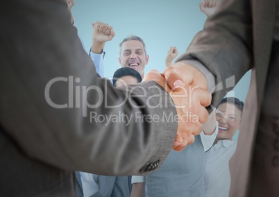 Composite image of Handshake in front of business people with blue background