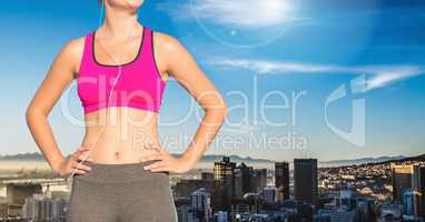 Composite image of woman Fitness Torso against city view