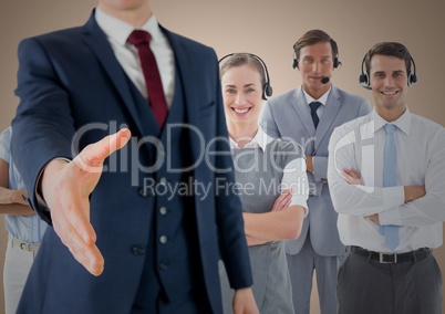 Handshake in front of business people with cream background