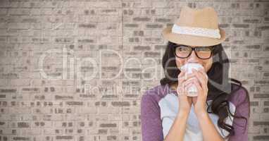 Composite image of Woman with coffee against brick wall