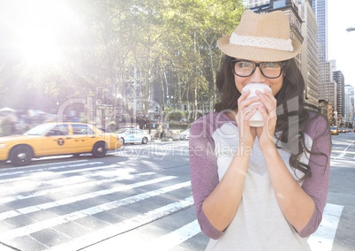 Woman drinking coffee on street with flare