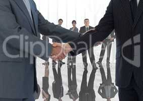 Handshake in front of business people at window