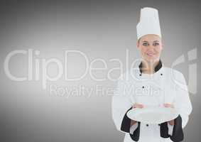 Chef with plate against grey background