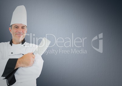 Chef with knife against grey background