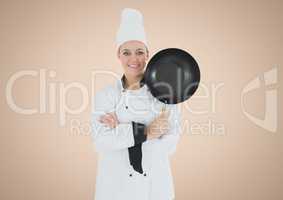Chef with frying pan against cream background