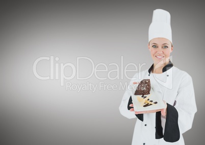 Chef with cake slice against grey background