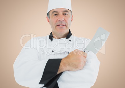 Chef with knife against cream background