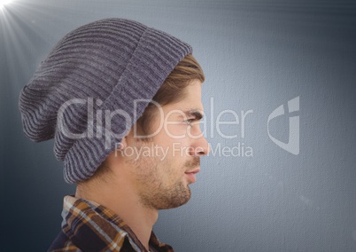 Composite image of Man with beanie against navy background with flare