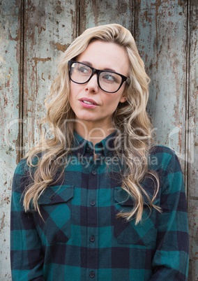 Woman with glasses against wood panel