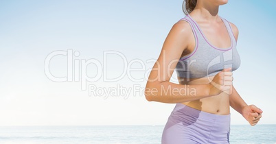 Fitness woman Torso who is running along the beach