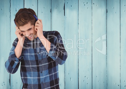 Man with headphones against wood panel