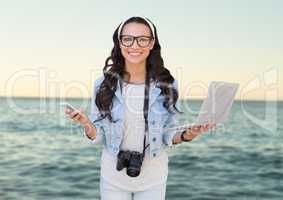 Composite image of Woman with phone and laptop in front of sea