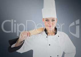 Chef with rolling pin against navy background