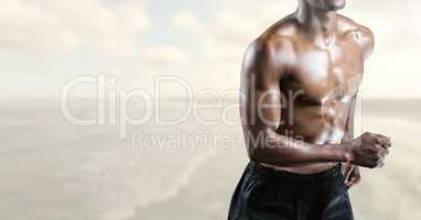 Composite image of man Fitness Torso against sea in background