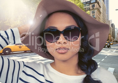 Composite image of Woman in summer hat against street in flare