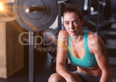 Fitness Woman and weights with flare in a gym