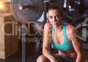 Fitness Woman and weights with flare in a gym