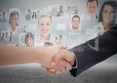 Composite image of Handshake in front of sky with business people