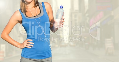 Fitness woman torso showing a bottle of water in the street