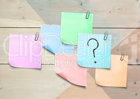Sticky Note with Question Icon against a wood wall