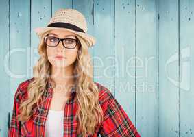 Composite image of Woman in fedora against blue wood panel