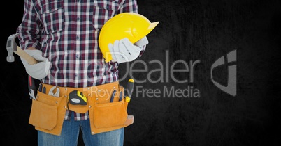 Carpenter with hammer against black background