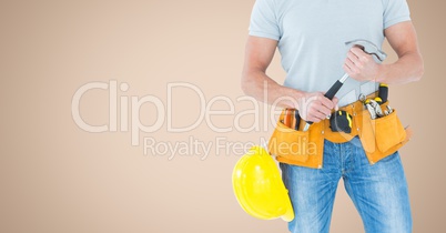 Carpenter torso with hammer against cream background