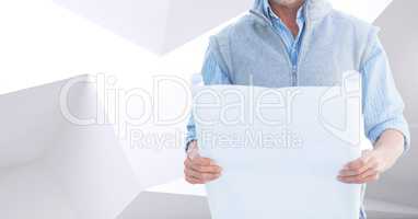 Architect Torso holding plan against white and grey background