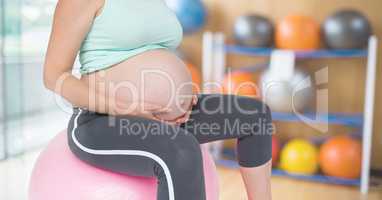 Pregnant Fitness woman Torso making fitness exercises in a gym