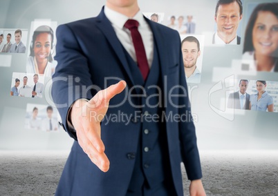 Composite image of Handshake in front of sky with business people