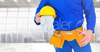 Carpenter with gloves against window background