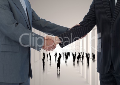 Composite image of Handshake in corridor with silhouettes